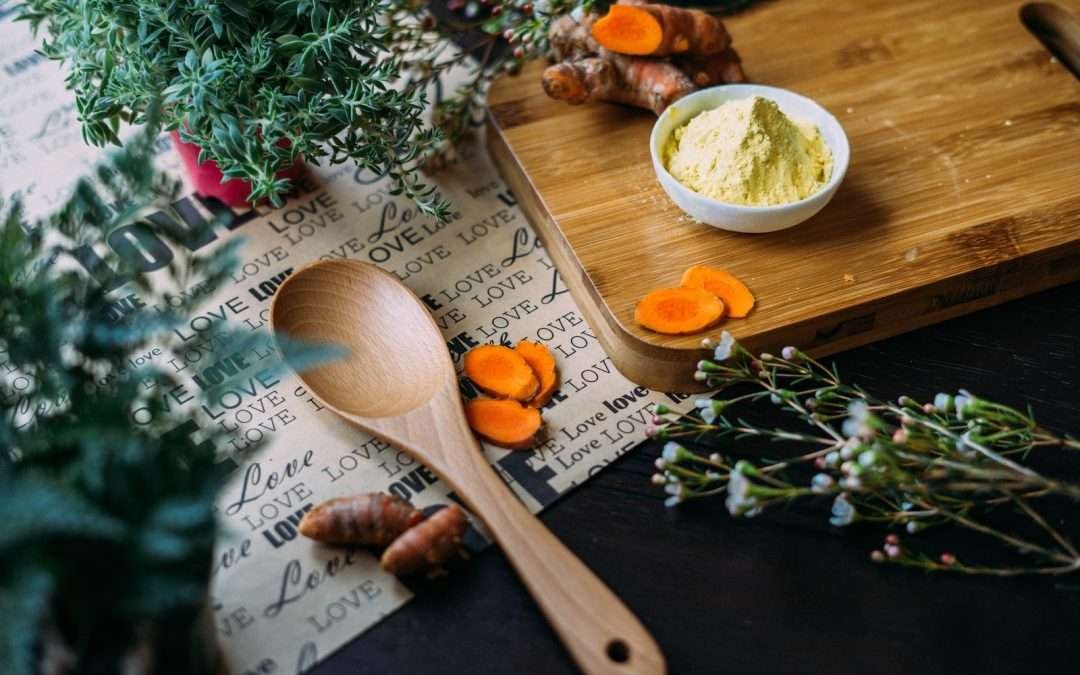 wooden ladle and chopping board with ginger during daytime
